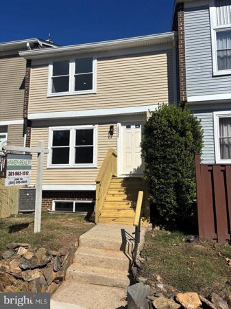 Front exterior with new siding, windows and entrance stairs