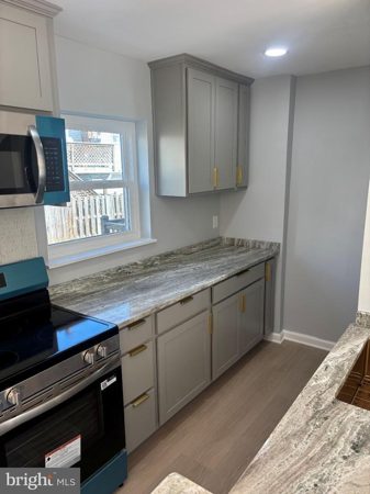 New kitchen with designer cabinets and stainless appliances