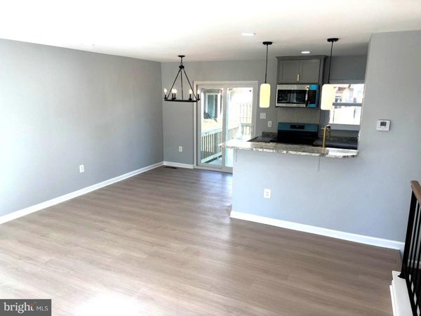 Living and dining area with recessed and designer lighting
